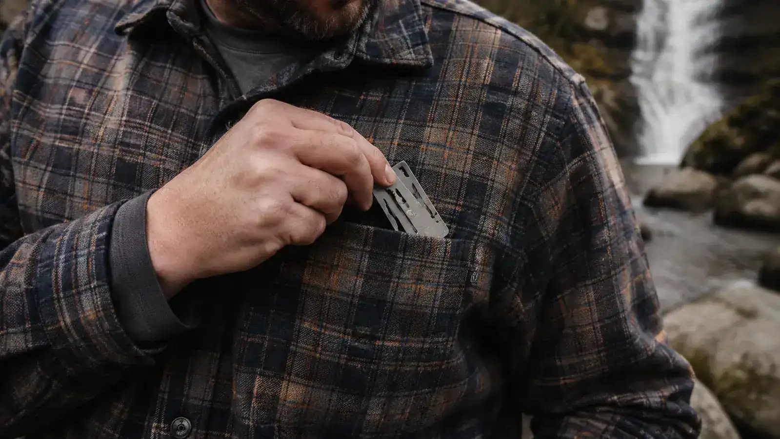 Close-up of a hand dropping a BRS-3000T stove into a shirt pocket to show how small it is