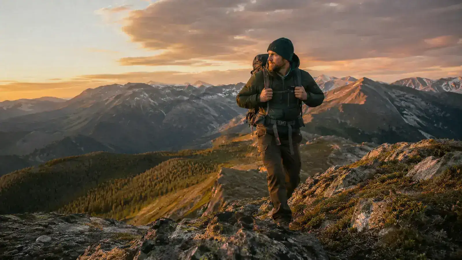 A backpacking tent pitched on a quiet ridge at golden hour with mountains in the background
