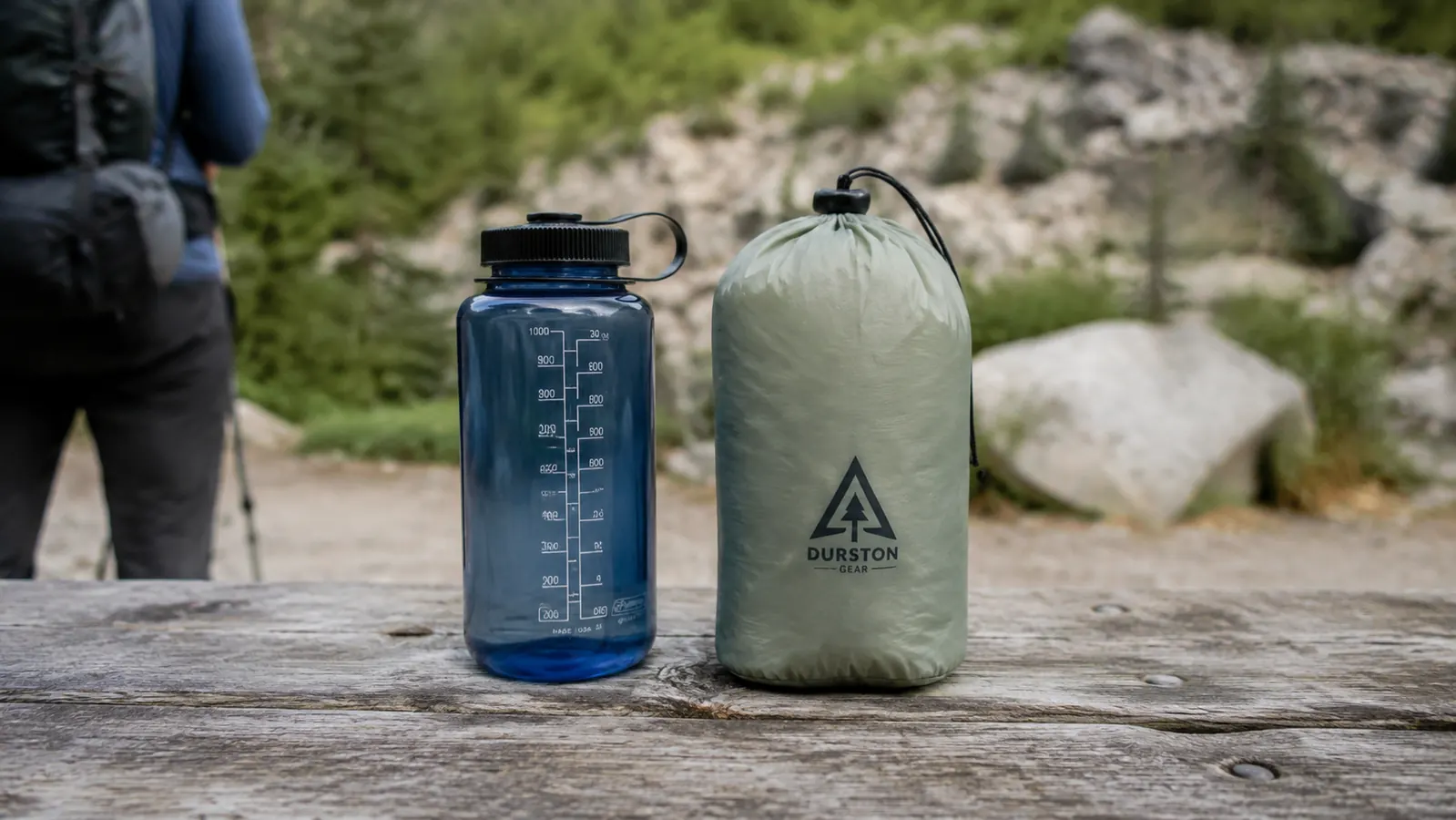 Naturehike Cloud-Up packed down next to a 32-oz Nalgene water bottle showing pack size comparison